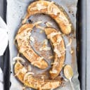 Baked bananas on Baking Tray Topped with Peanut Butter and Coconut