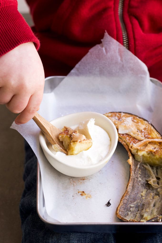 Child Eating Baked Banana with Yoghurt