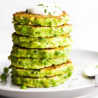 Side Shot of a Stack of Pea Fritters Topped on a Plate.
