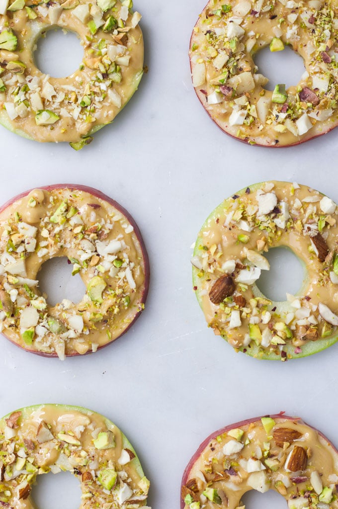 Apple Slices Topped with Peanut Butter and Chopped Nuts