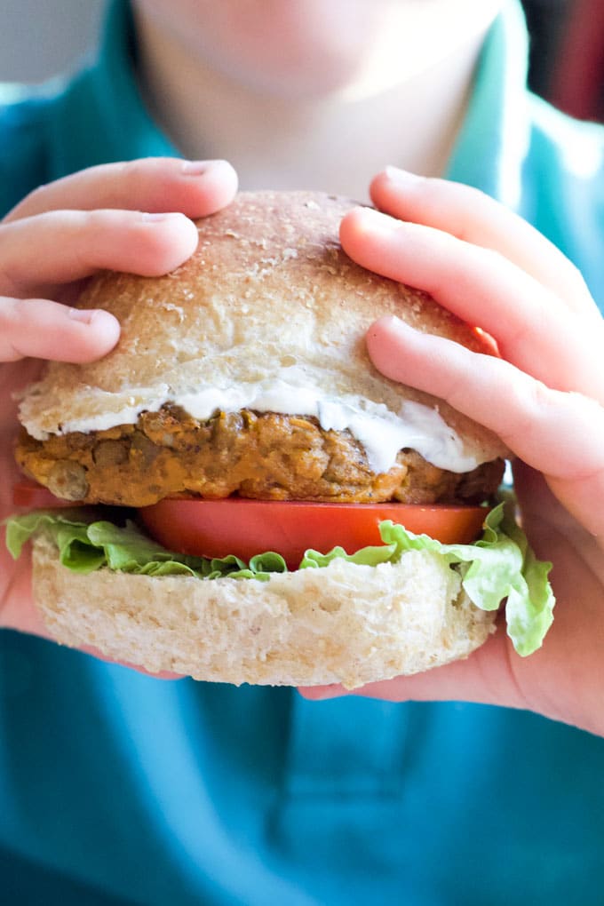 Child Holding Lentil Burgers in a Bun