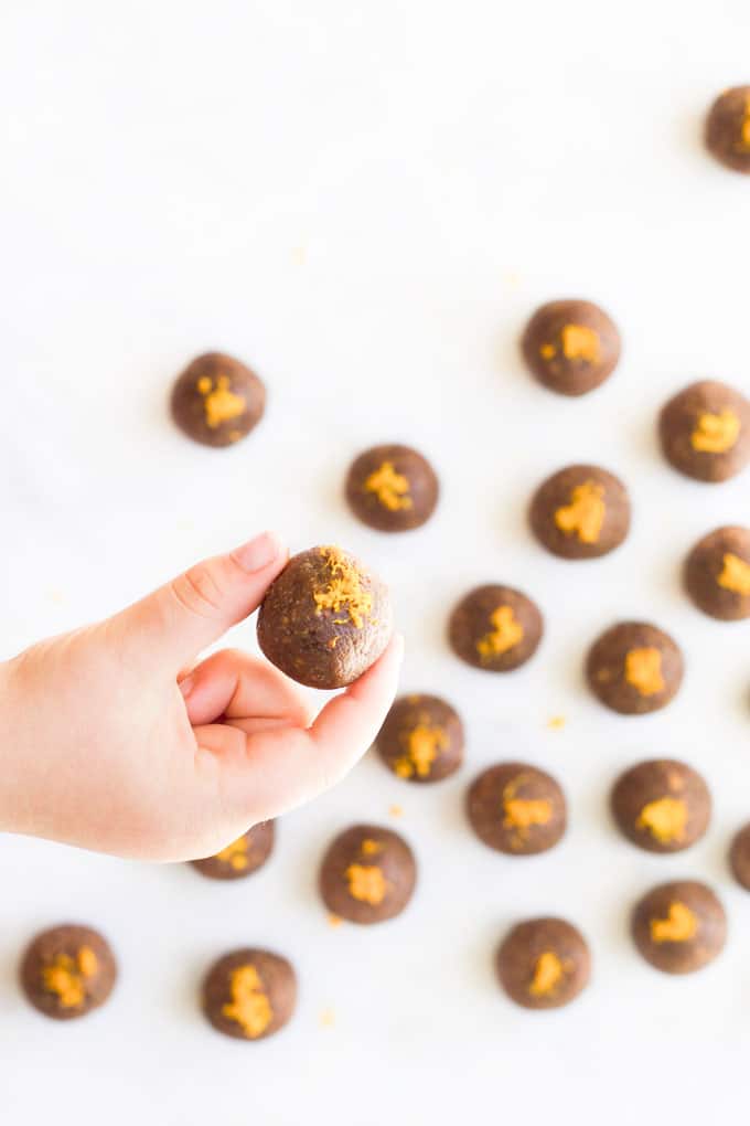 Child Holding Chocolate Orange Energy Balls