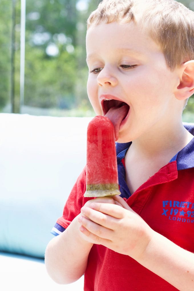 Child Licking Watermelon Popsicle