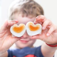 Child Holding Heart Shaped Eggs