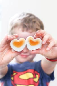 Child Holding Heart Shaped Eggs