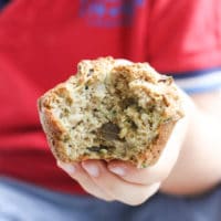 Child Holding a Zucchini Muffin with Bite Out
