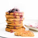 Side on Shot of Stack of Baby-led Weaning Pancakes Topped with Yogurt and Berries.