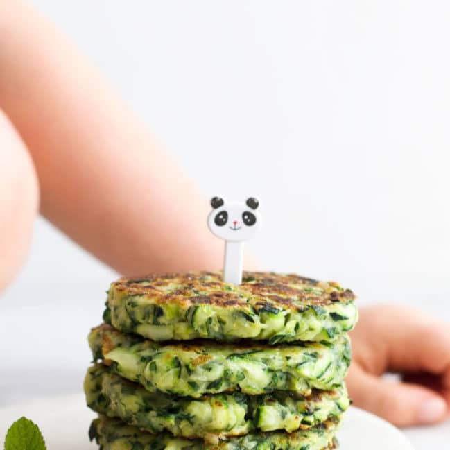 Stack of Zucchini Fritters with Kid Fork Pic on Top
