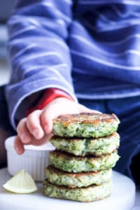 Child Grabbing Broccoli Fritter from Stack