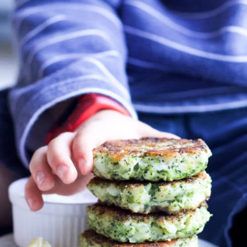 Child Grabbing Broccoli Fritter from Stack