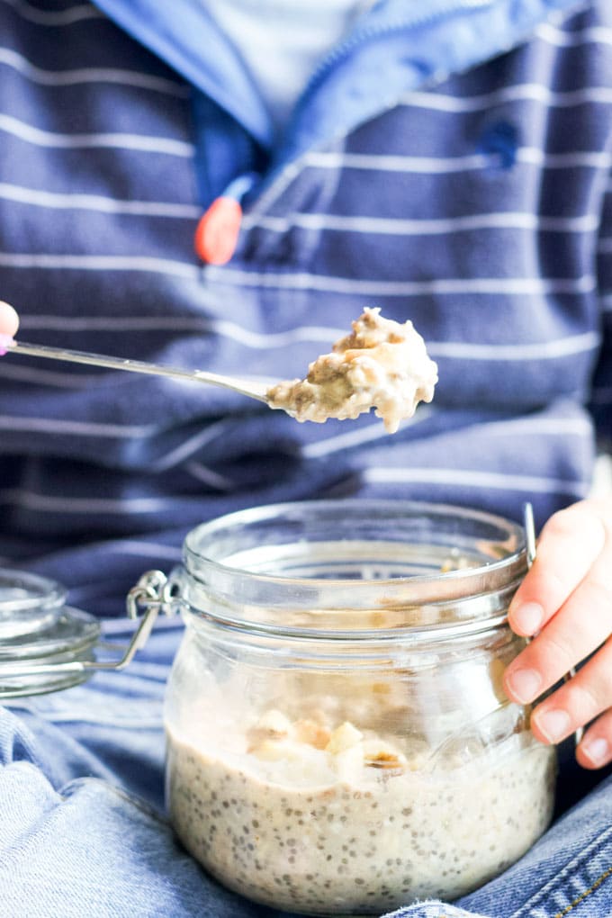 Child Taking Spoon of Overnight Oats from Jar