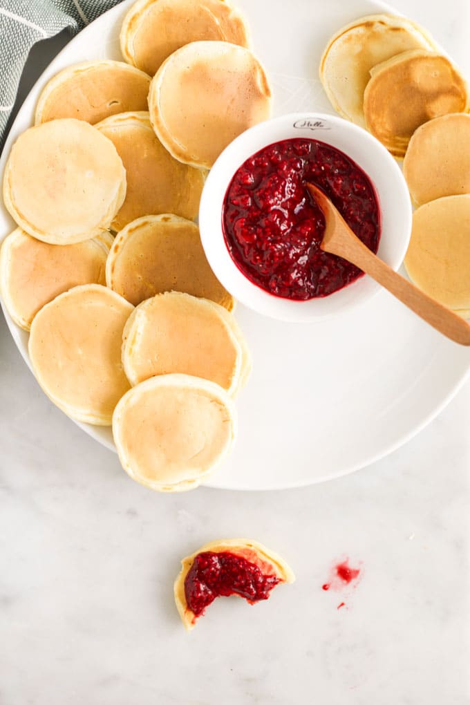 Dop Down View of a Plate of Mini Pancakes With Bowl of Chia Jam
