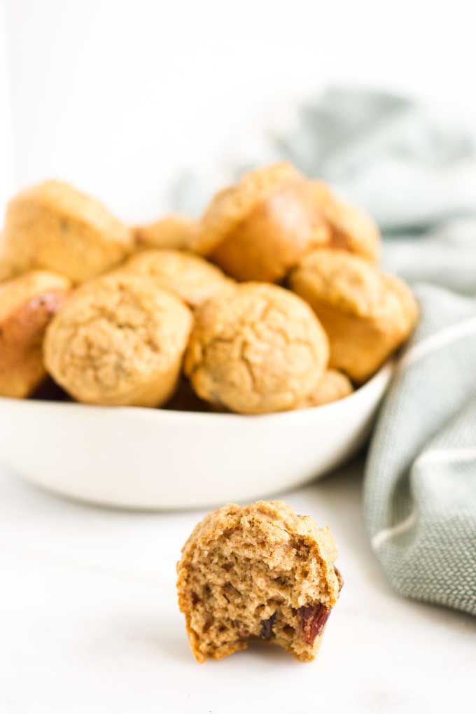 Bowl of Mini Sweet Potato Muffins for Babies. One with bite taken out.