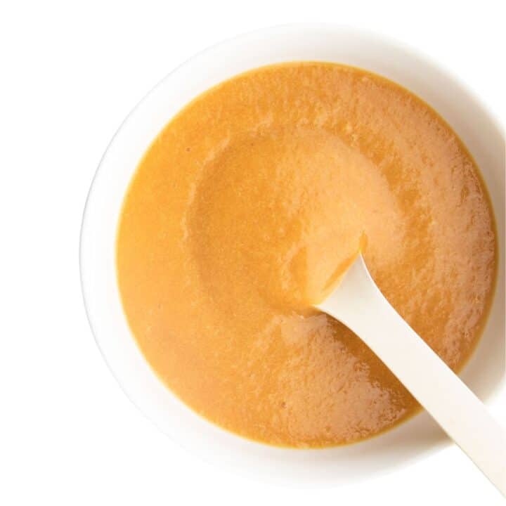 Peach Puree in White Bowl with White Spoon.