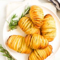 Hasselback Potatoes on Plate with Sprigs of Rosemary