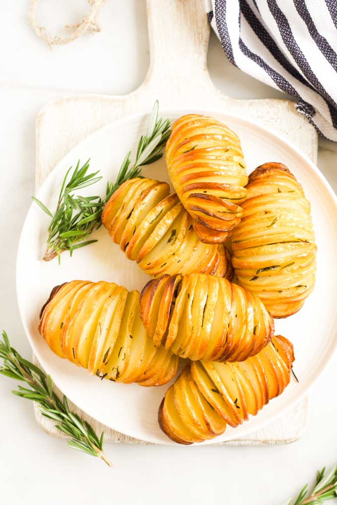 Hasselback Potatoes on Plate with Sprigs of Rosemary