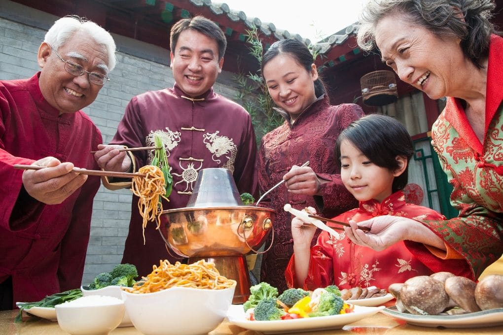 Family Gathered Around the Table Serving a Meal