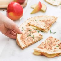 Child Grabbing Apple and Cheese Quesadilla