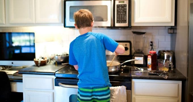 Young Boy Cooking at Stove Top