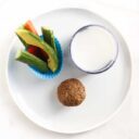 Mini Muffin on a Plate with Cut Veggies and a Glass of Milk