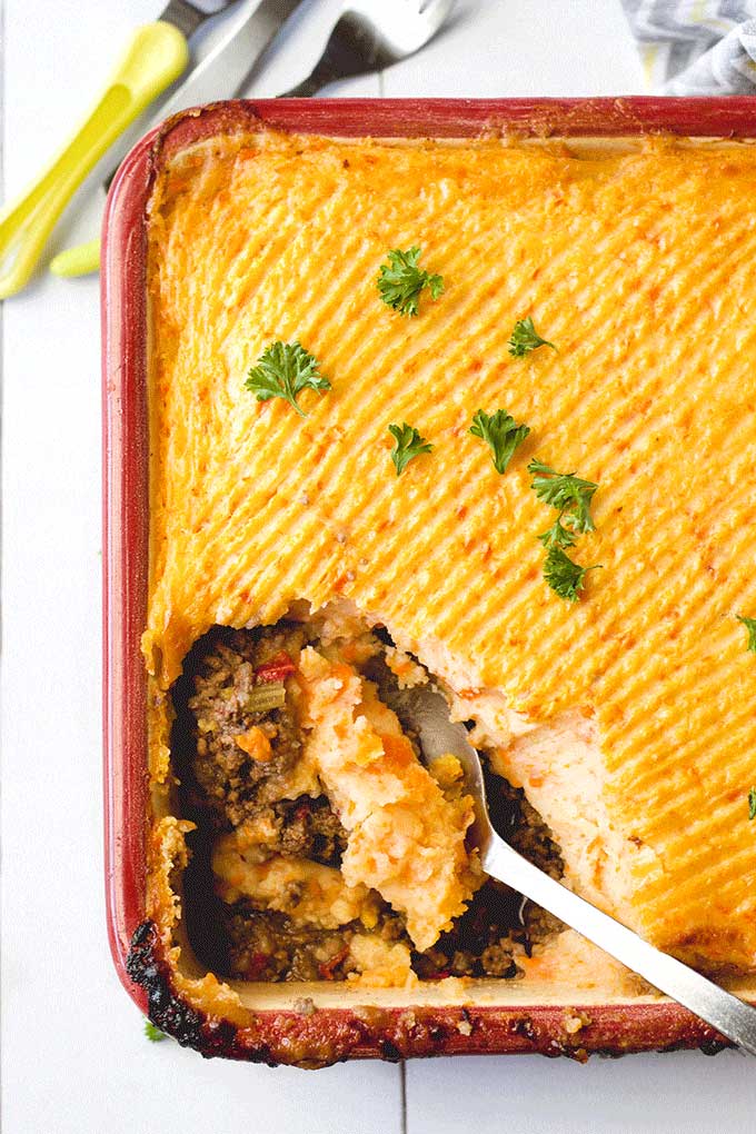 Top Down View of Cottage Pie in Baking Dish with Portion Removed