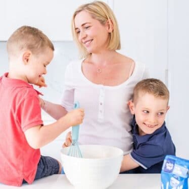 Mum with Two Boys in the Kitchen with Cooking Ingredients and Bowl