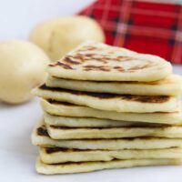 Stack of Tattie Scones with Potatoes adn Tartan Napkin in Background