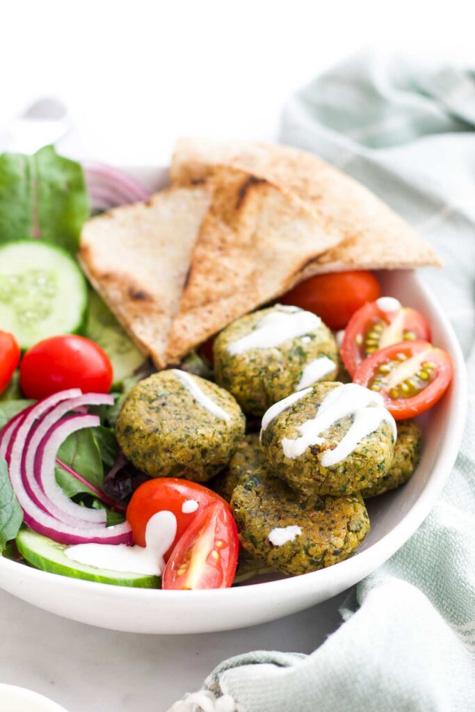 Baked Falafel in Bowl with Salad and Pita Triangles.
