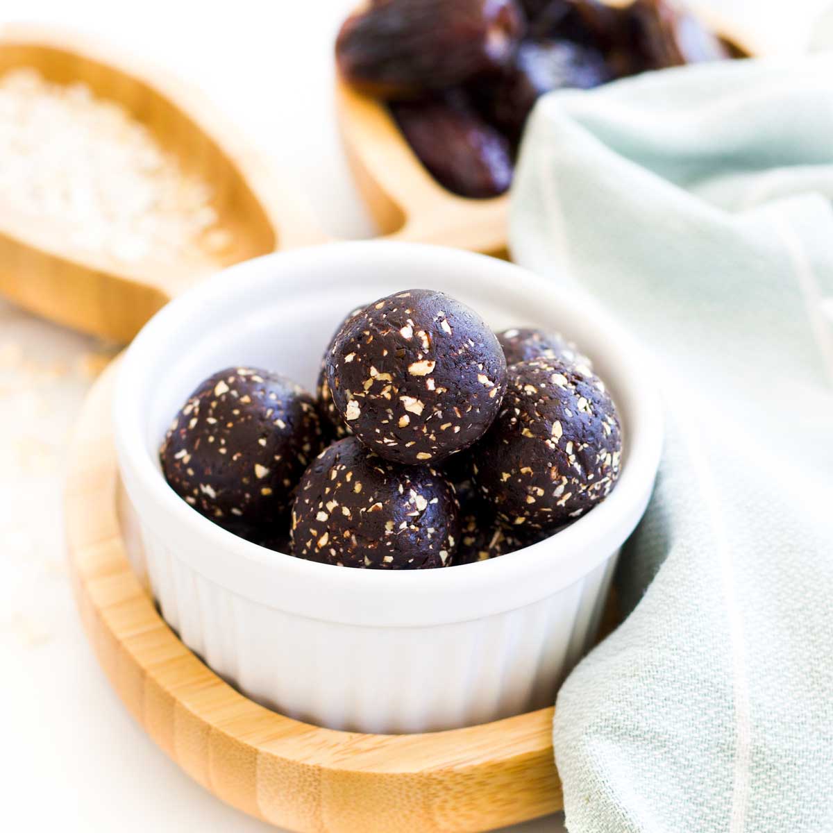 45 Degree Shot of cocoa Balls in White Bowl Sitting on Wooden Bunny Plate.