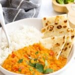 Bowl of Red Lentil Curry with Rice and Roti Bread