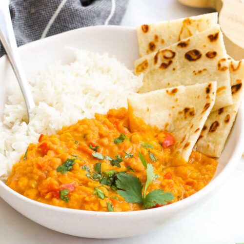 Bowl of Red Lentil Curry with Rice and Roti Bread