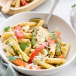 Bowl of Penne Pasta and Roasted Vegetables Scattered with Parmesan Cheese