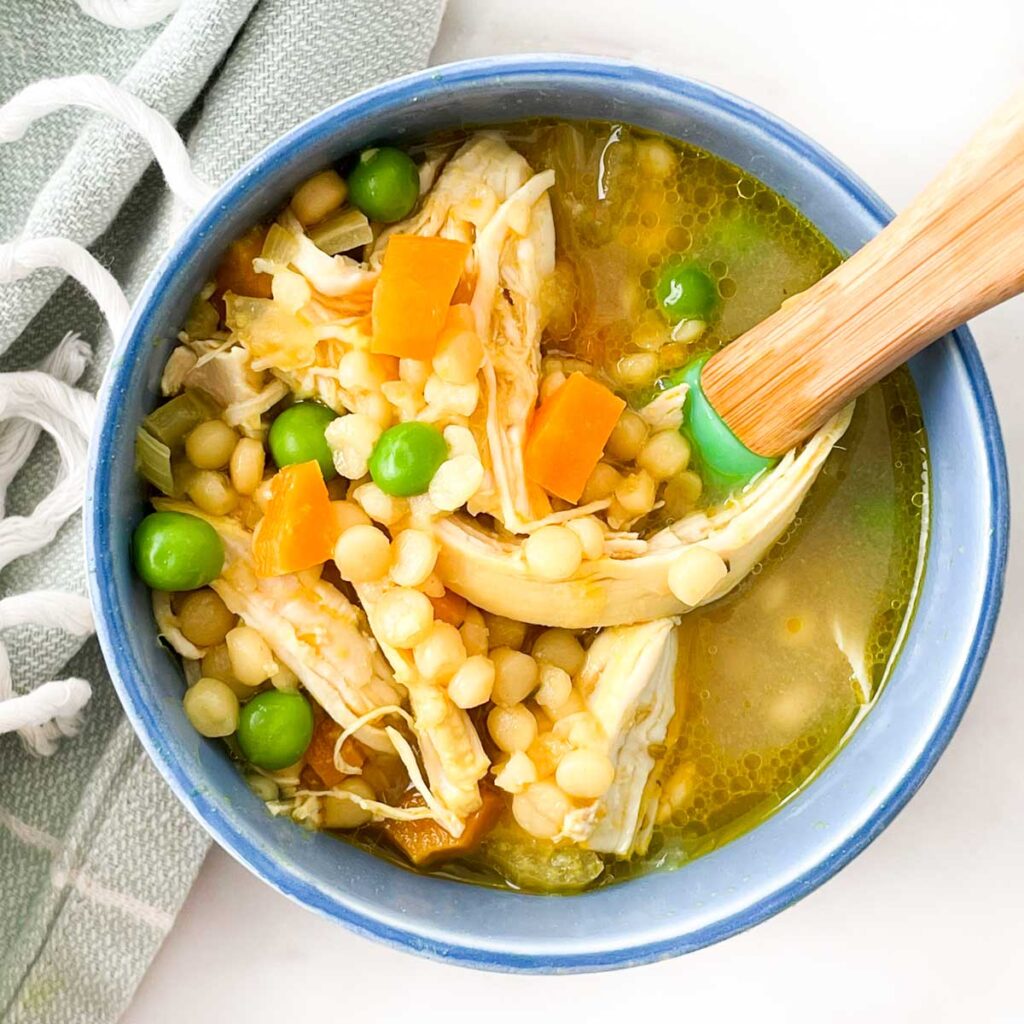 Top Down Shot of Chicken Soup in Toddler Bowl