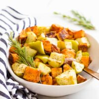 Roasted Sweet Potato and Apple Chunks in Serving Bowl with Sprig of Rosemary