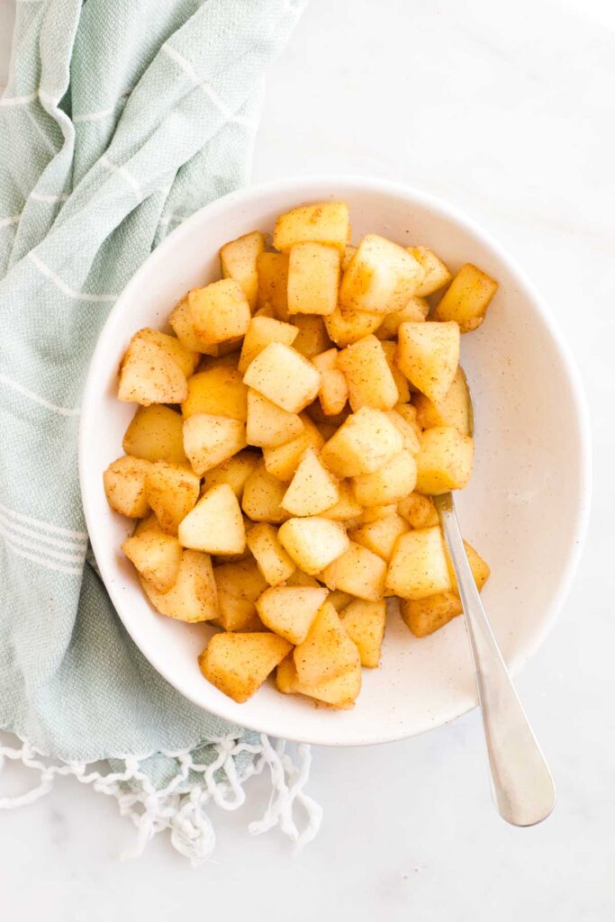 Stewed Apples in Bowl with Serving Spoon