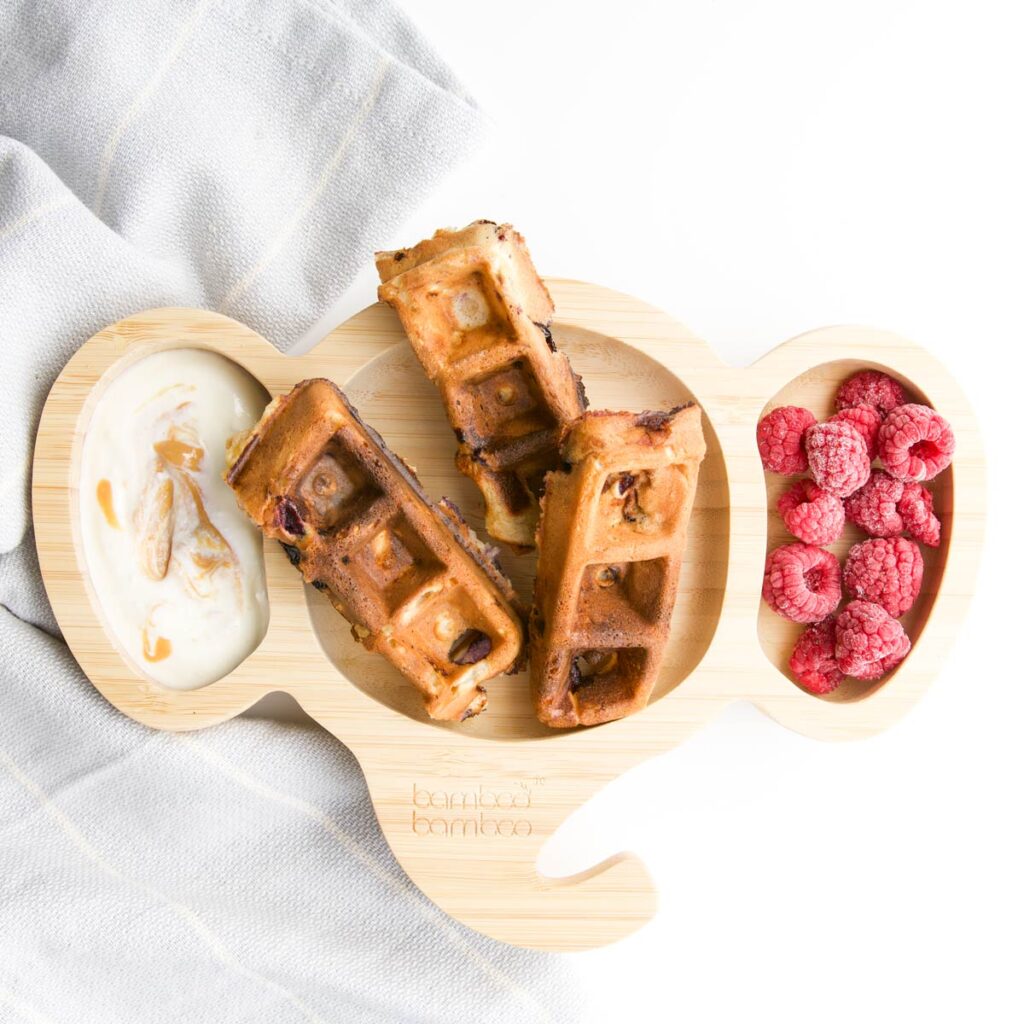 Waffles Cut Into Strips on Baby Plate with Yogurt Dip and Raspberries