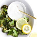 Cooked Broccoli in Bowl with Yogurt Dip and Lemon Slices