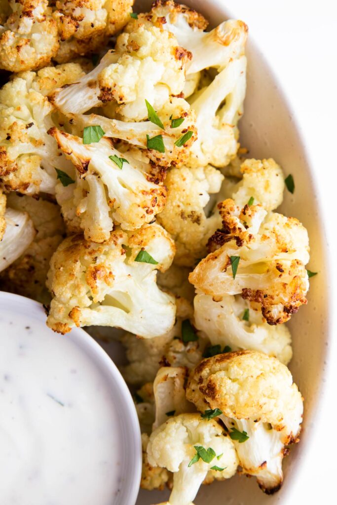 Close Up Shot of Cooked Cauliflower in Bowl with Dip