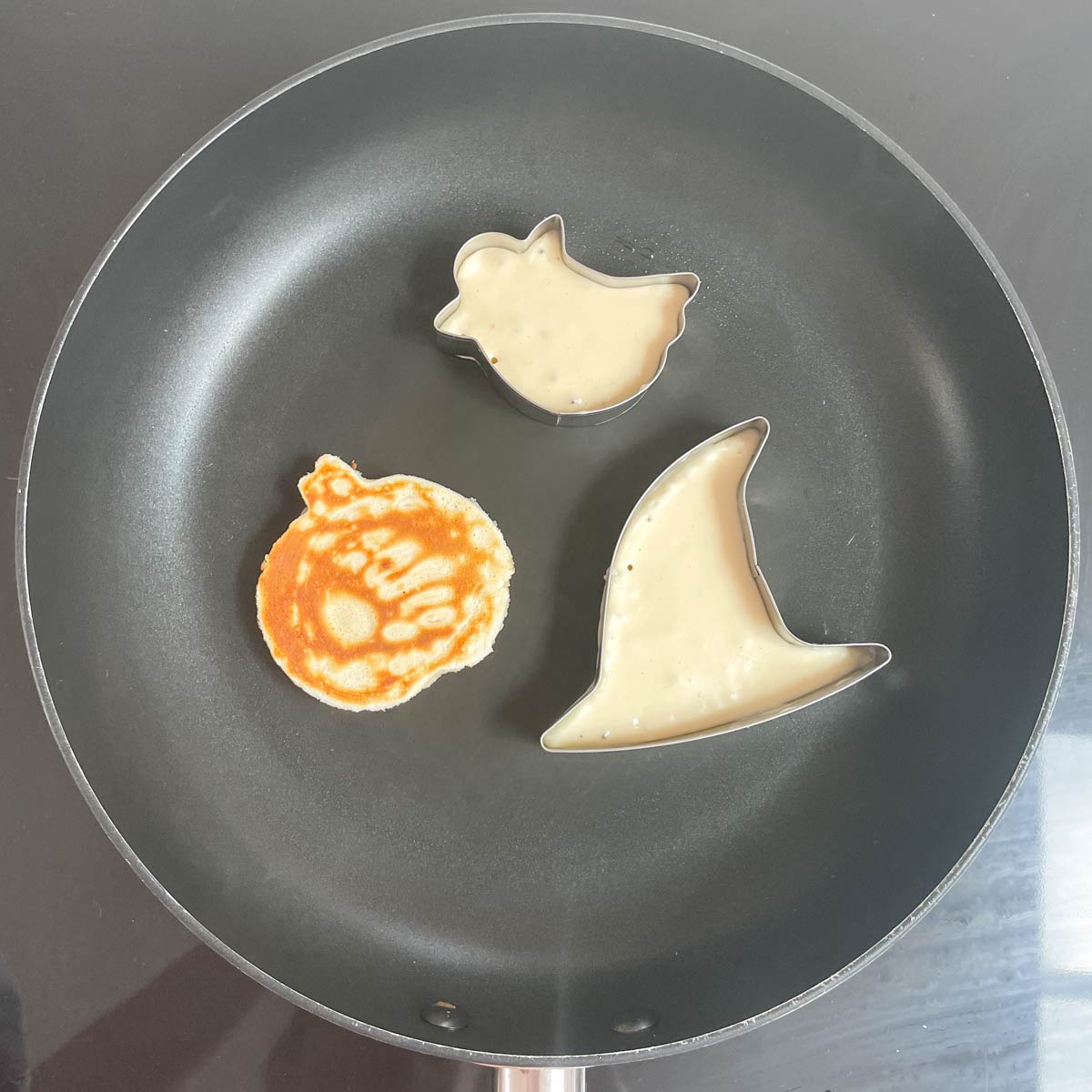 Metal Halloween Cookie Cutters in Pan filled with Pancake Batter