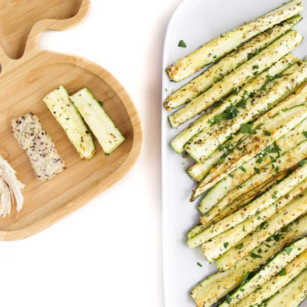 Roasted Zucchini (courgette) on Baby Plate with Quinoa and Chicken. Side Plate of Roasted Zucchini to the Side.