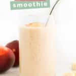 Side Shot of Banana Peach Smoothie with Peach and Banana in Background. Text Overlay “Banana Peach Smoothie”