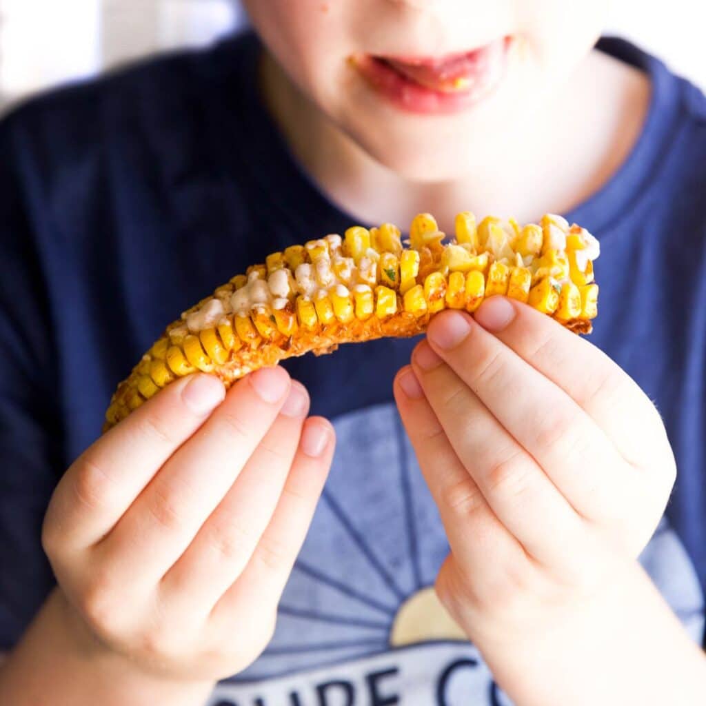 Child Holding Corn Rib