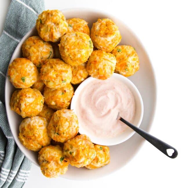 Baby Chicken Meatballs in White Bowl with Bowl of Smoked Paprika Dip.