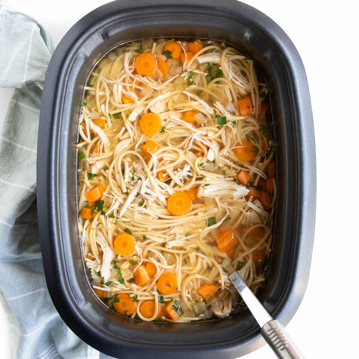 Top Down Shot of Chicken Noodle Soup in Slow Cooker.