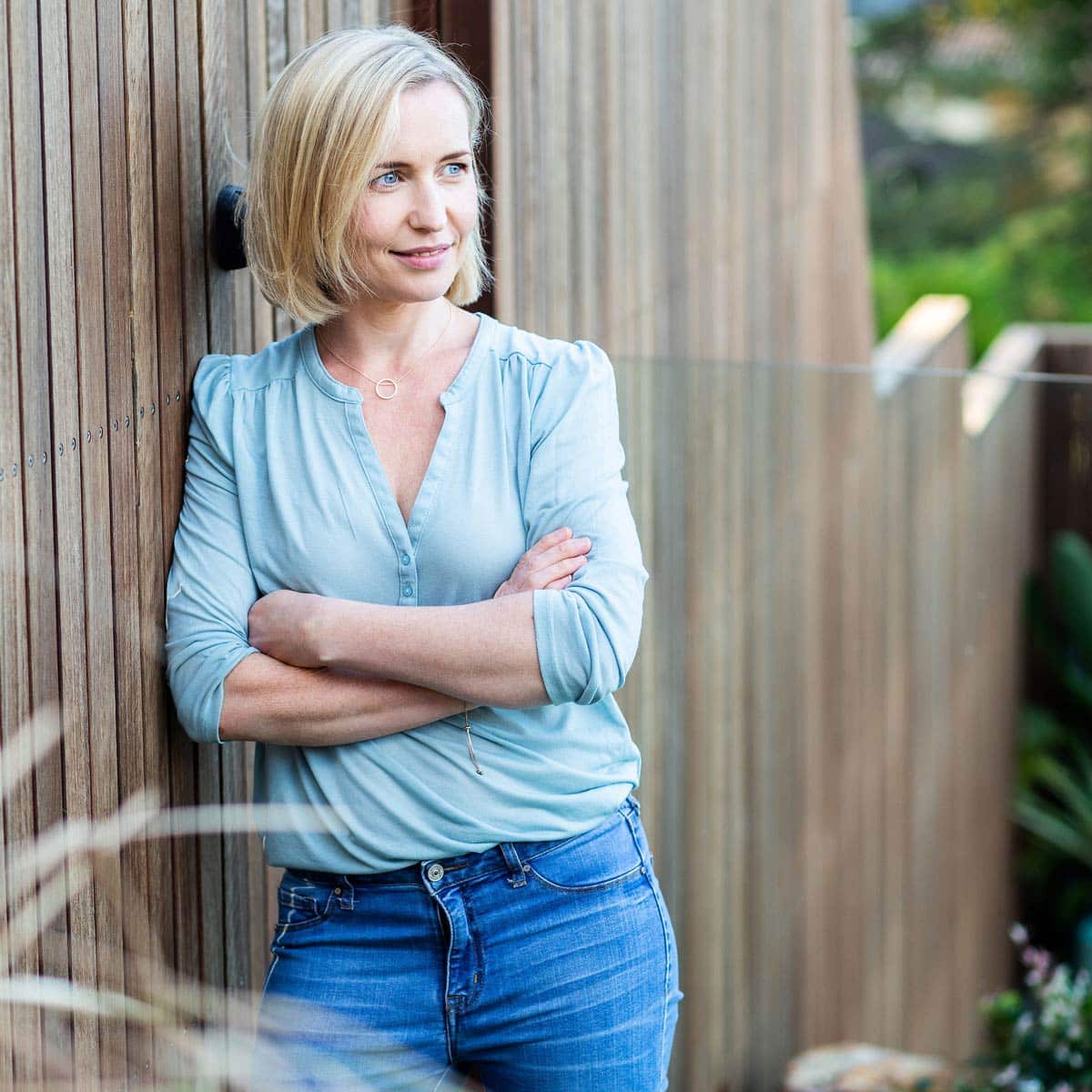 Amy Whiteford Standing Against Wooden Fence.