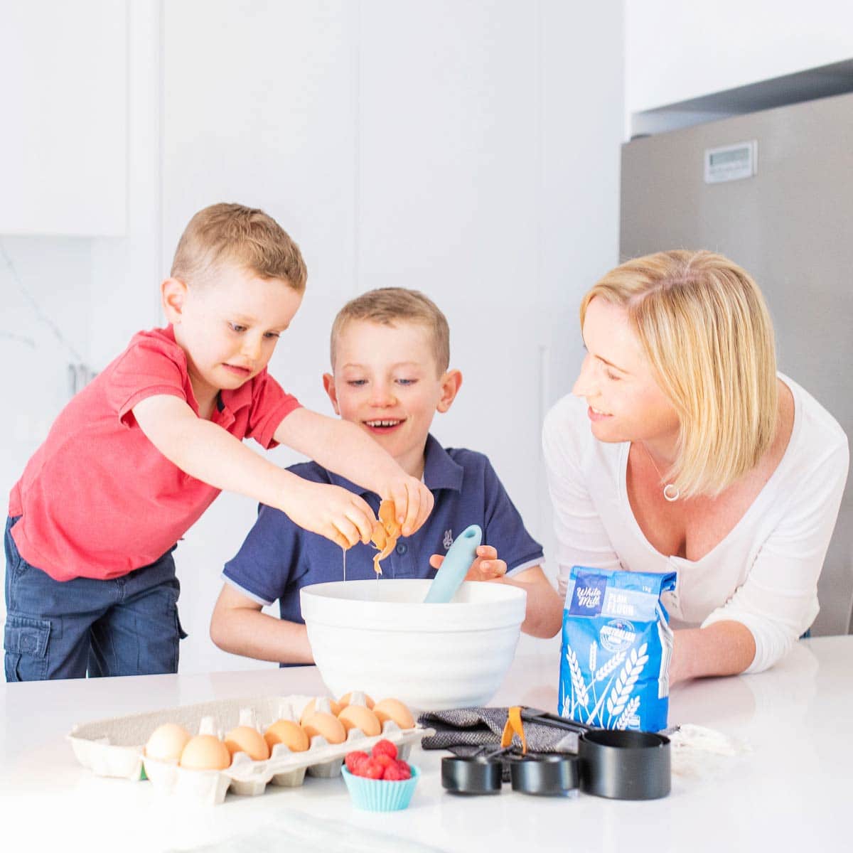 Amy in Kitchen With Her Two Boys Baking. Rory Cracking Egg into Bowl with Amy and Finlay Watching. 