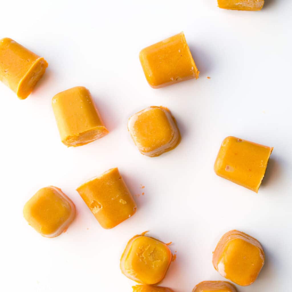 Cubes of Frozen Lentil Puree Scattered on White Background.