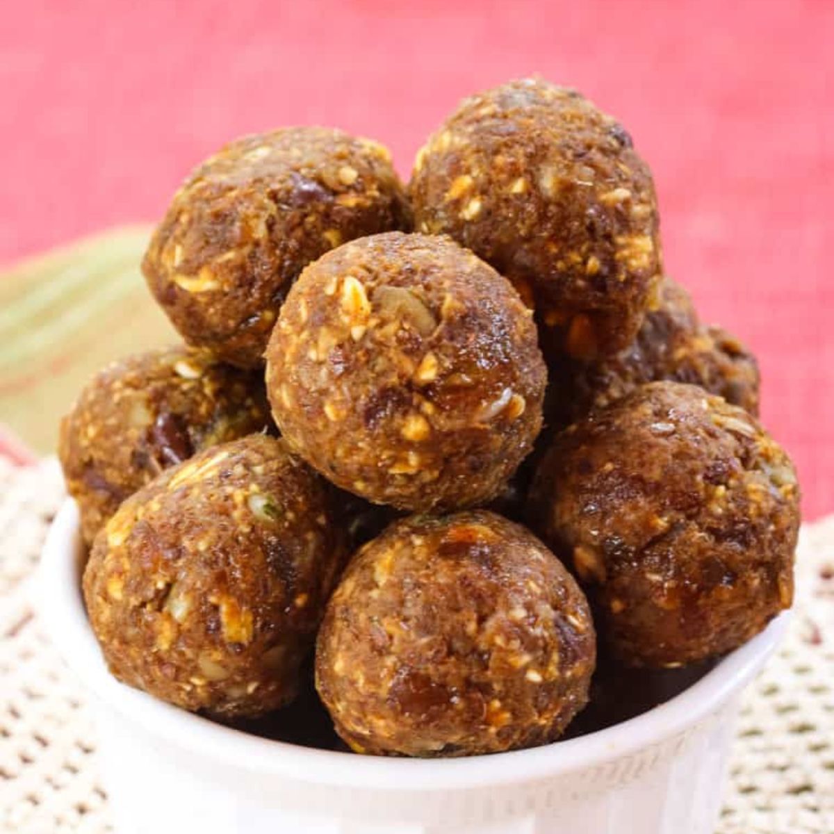 Pumpkin Spice Energy Bites in White Bowl with Pink Background. 