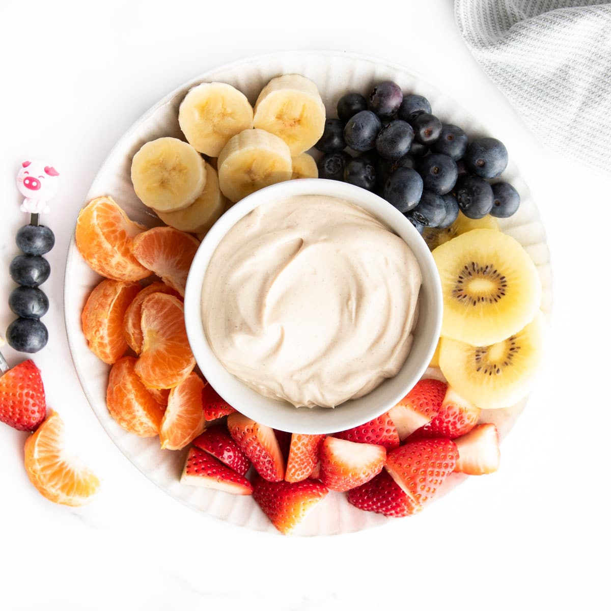 Peanut Butter Cottage Cheese Dip on Plate With Chopped Fresh Fruit.