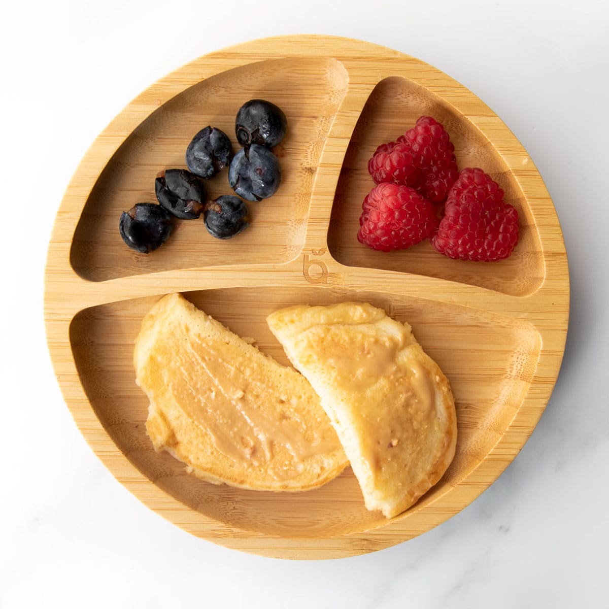 Yogurt Pancakes Topped with Peanut Butter on Baby Plate with Berries.